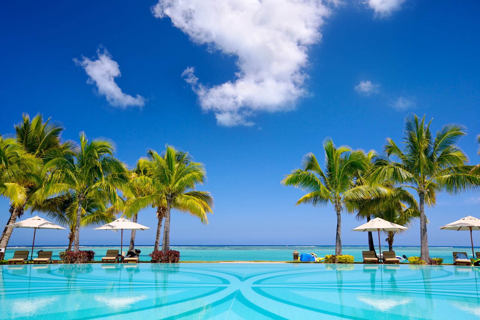 Tropical beach resort with  lounge chairs and umbrellas in Mauritius
